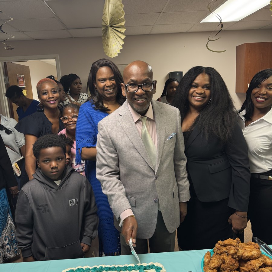 Bishop Lewis and church family celebrating together at a fellowship banquet