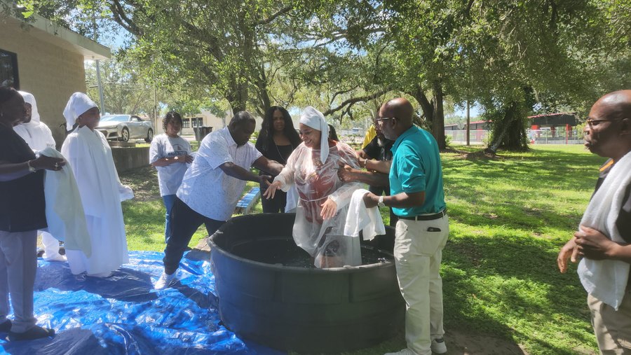 Outdoor water baptism celebration at First Victory Cathedral