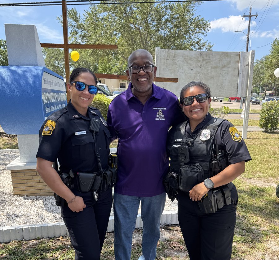 Bishop Michael W. Lewis, Sr. with Tampa Police officers outside First Victory Cathedral