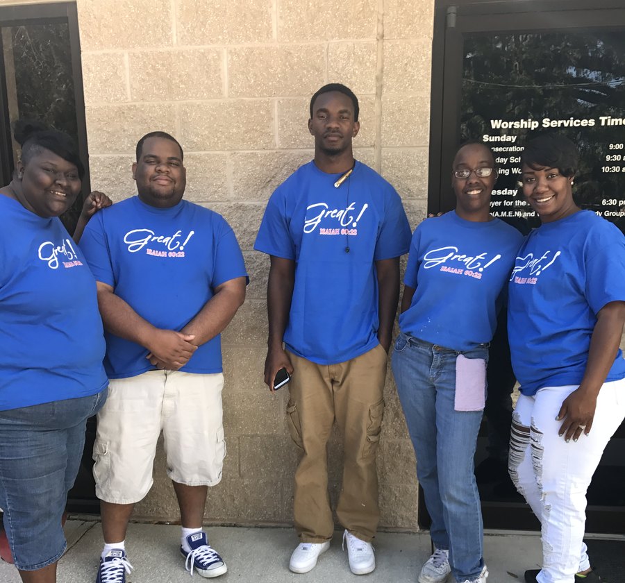 First Victory Cathedral Youth Ministry team standing together outside the sanctuary doors